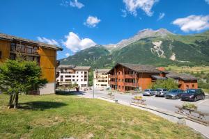 a view of a town with a mountain in the background at Balcons H 024 - PARC NAT VANOISE appart 6 pers in Termignon +5 photos