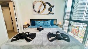 a bedroom with a large bed with two teddy bears on it at Sky-High oasis heated Pool & Gym Miami Skyline Vista in Miami