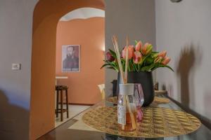 a glass table with a vase of flowers on it at La Lancia D'Oro in Arezzo