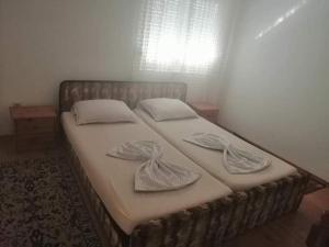 a bed in a bedroom with two pillows on it at Vila Bula 1 in Donji Štoj
