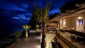 a villa with a view of the ocean at night at Infinity Beach House by KLV in Argostoli