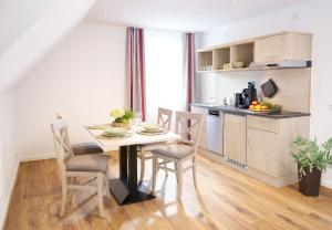 a kitchen and dining room with a table and chairs at Haus Dumicketal in Drolshagen