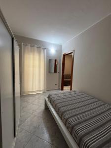 a bedroom with a bed in a room with a window at Dimora Speranza in San Giovanni Teatino