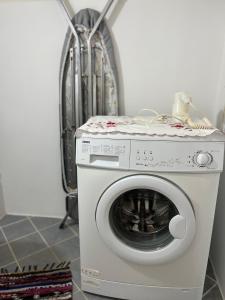 a washing machine with a cloth on top of it at Sunshine 1 in Leonidio