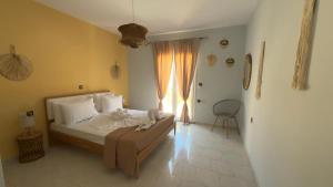 a bedroom with a bed and a window at Ioli's Apartments Zante in Alykes