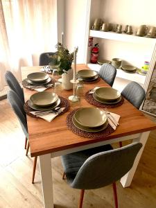a dining room table with chairs and plates on it at Relax Fewo in Hagen +15 photos
