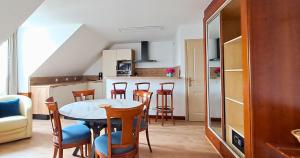 a kitchen and dining room with a table and chairs at Au jardin d'à côté in Montreuil-sur-Mer