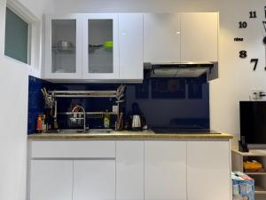 a kitchen with white cabinets and a sink at High-class apartment with beautiful view in Ấp Ðông An (1)