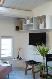 a living room with a flat screen tv on a wall at [Ferrara Centro - Karumi Apt] in Ferrara +26 photos