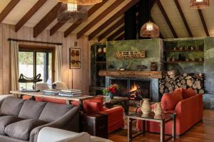 a living room with a couch and a fireplace at Futangue Hotel & Spa in Lago Ranco