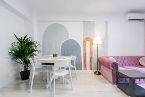 a living room with a table and a couch at The Arch apartment in Voluntari