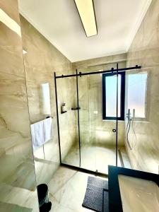 ein Badezimmer mit Dusche mit Glastür in der Unterkunft Luxurious & Spacious Old Bazaar Apartment in Tirana