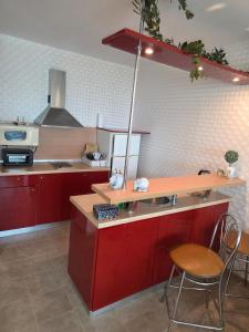 a kitchen with red cabinets and a table and chairs at Apartment Miramar Palace in Sunny Beach
