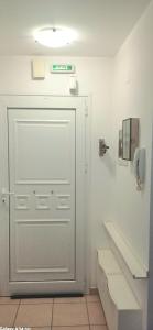 a white door in a bathroom with a phone at Maria's Studio No3 in Heraklion in Thérissos +13 photos