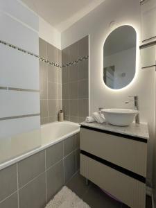 a bathroom with a sink and a tub and a mirror at Duplex Moderne 8per&3Ch&10 min Disney&Parking free in Magny-le-Hongre +39 photos