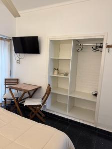 a bedroom with a desk and a table and a tv at La Casona de Lula y Eduardo in Tandil +12 photos