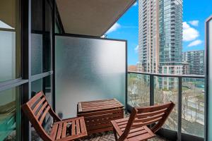 two chairs and a table on a balcony at Superior 1Bd & DEN Apartment with Balcony in Toronto +11 photos