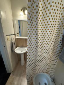 a bathroom with a shower curtain and a sink at La Casona de Lula y Eduardo in Tandil