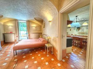 a bedroom with a bed in a room with a kitchen at ' La Tavernetta ' del Principe in Oulx
