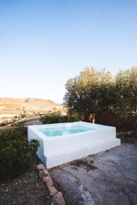 a swimming pool in the middle of a yard at Cortijo La Risca in Almería
