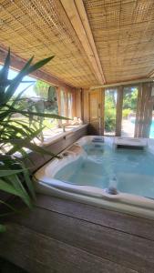 a large jacuzzi tub in a wooden room with at Entre les pins et les oliviers in Bormes-les-Mimosas +14 photos