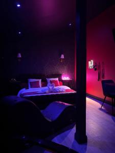 a bedroom with two beds in a dark room at Le Love des monts in Saint-Jean-de-Monts