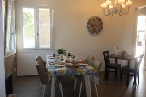 a dining room with a table with a table cloth at Villa pace D'oro in Argelato