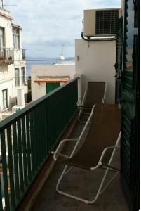 two chairs sitting on the balcony of a building at Canneto appartments in Lipari