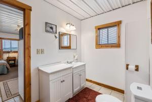 a bathroom with a sink and a toilet at Cozy Riverfront Cabin in Decatur Ideal for Fishing Hunting Relaxation in Onawa