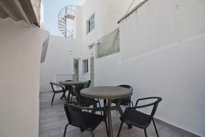 a group of tables and chairs in a room at New Village Guest House in Lagos