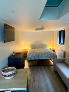 a living room with a bed and a couch at Katrins Nest in Southbourne