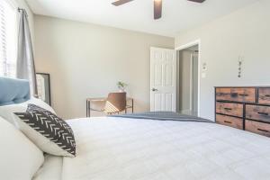 a bedroom with a large bed and a dresser at Boulevard Stays Tranquil 1BR King Suite Pool Gym Parking 03 in Dallas