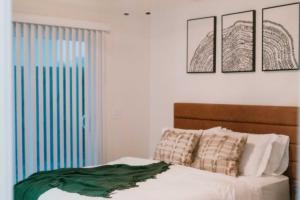 a bedroom with a bed and four pictures on the wall at 2 Beds, Built-in Office, Gated Entry in Council Bluffs