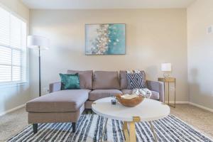 a living room with a couch and a table at Boulevard Stays Tranquil 1BR King Suite Pool Gym Parking 01 in Dallas