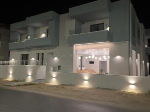 a building with lights on the side of a street at Ensueno Apartments Keramoti in Keramotí