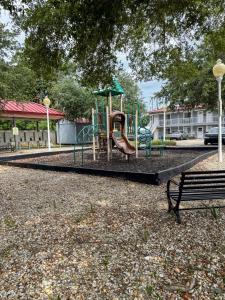 a playground with a slide in a park at Cozy 1 bed 1 bath Condo with pool, close to beach in Biloxi