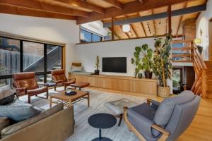 a living room filled with furniture and a flat screen tv at Mid Century on Eastview in Torquay
