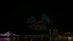 a statue of a giraffe is lit up at night at All New Diamond House in Busan
