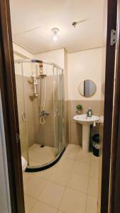 a bathroom with a shower and a sink at Bella Suite Netflix Pool Great View in Manila