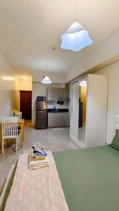 a living room with a bed and a kitchen at Bella Suite Netflix Pool Great View in Manila +7 photos