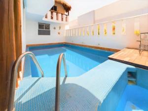 a swimming pool with a bench in a building at Stylish 2BR Retreat with Private Patio in Playa del Carmen