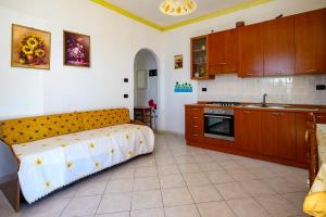 a kitchen with a bed in the middle of a room at Vista Mediterranea in Pizzo