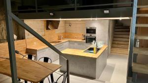 a kitchen with a counter and a table with chairs at La Baume du Delà in Saint-Chamas
