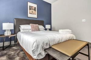 a bedroom with a large bed with blue walls at Boulevard Stays Elegant 1BR Pool Gym Parking in Richardson