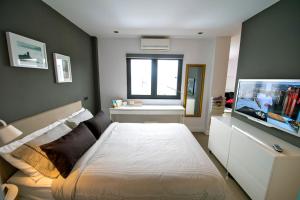 a bedroom with a bed and a flat screen tv at Luxury apartment in Las Palmas de Gran Canaria