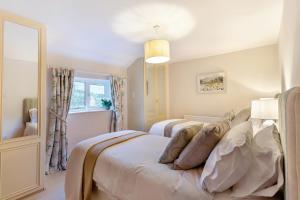 Postel nebo postele na pokoji v ubytování East Paddock Cottage