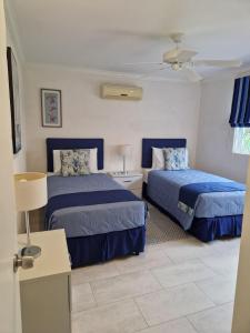 a hotel room with two beds in a room at Villa in Sunset Crest, Holetown in Saint James +29 photos