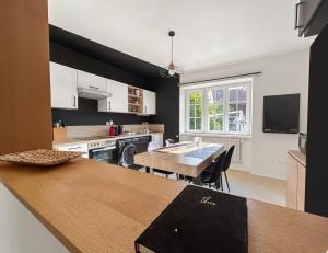 a kitchen with a table and a dining room at Family Lounge proche de Europapark et Rulantica in Rhinau