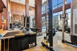 a fitness room with a gym with tread machines at Boulevard Stays Bright 1BR Suite Pool Parking Gym J in Richardson