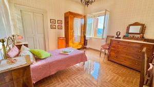 a bedroom with a bed and a dresser and a mirror at Casa di Nonna in Montefranco